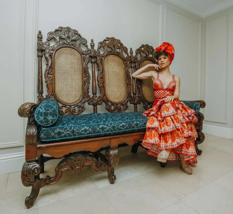 This is an image of a lady wearing a custom made ethnic dress made by Betzabe Pujaico Designs in North Miami, FL.