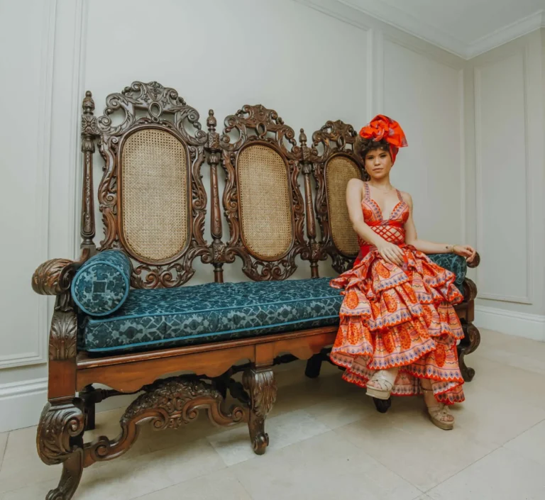 This is an image of a lady wearing a custom made ethnic dress made by Betzabe Pujaico Designs in North Miami, FL.