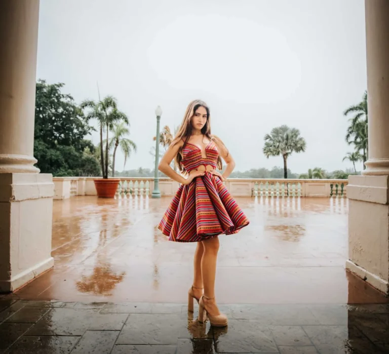 This is an image of a lady wearing a custom made ethnic dress made by Betzabe Pujaico Designs in North Miami, FL.