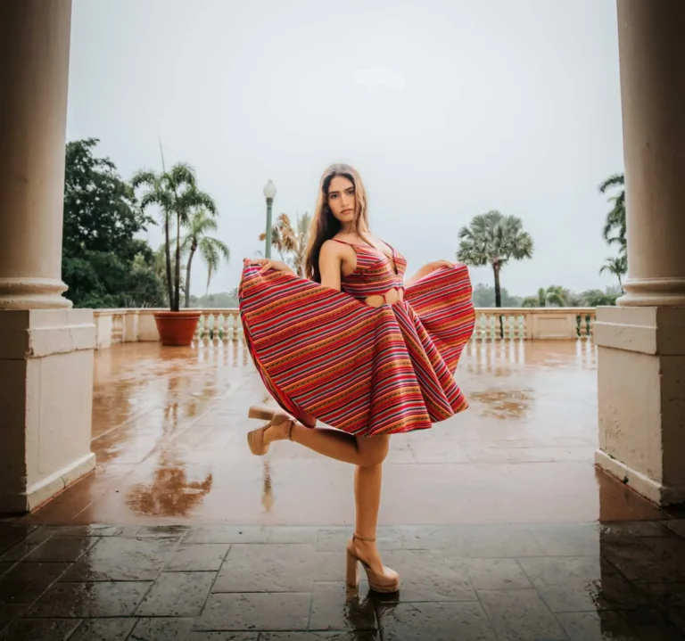 This is an image of a lady wearing a custom made ethnic dress made by Betzabe Pujaico Designs in North Miami, FL.