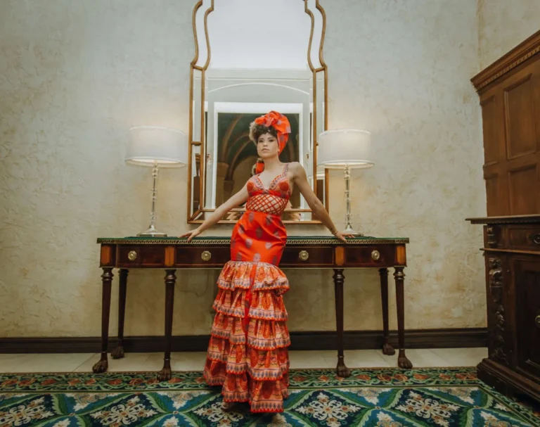 This is an image of a lady wearing a custom made ethnic dress made by Betzabe Pujaico Designs in North Miami, FL.