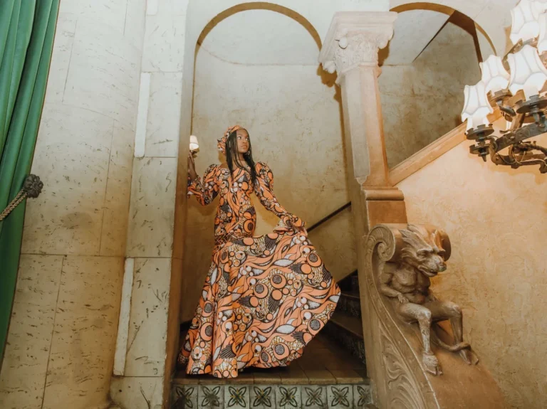 This is an image of a lady wearing a custom made ethnic dress made by Betzabe Pujaico Designs in North Miami, FL.