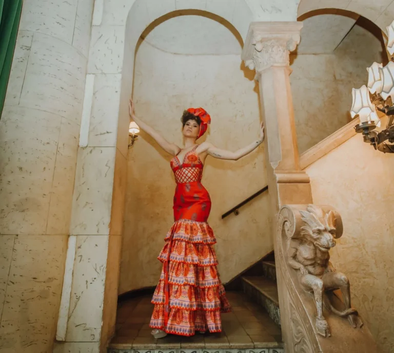 This is an image of a lady wearing a custom made ethnic dress made by Betzabe Pujaico Designs in North Miami, FL.