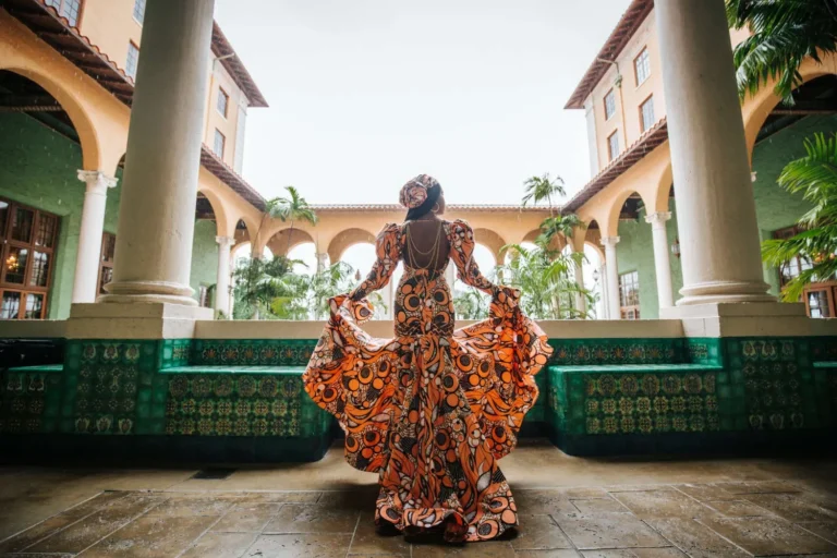 This is an image of a lady wearing a custom made ethnic dress made by Betzabe Pujaico Designs in North Miami, FL.