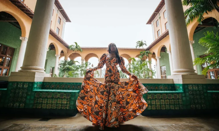This is an image of a lady wearing a custom made ethnic dress made by Betzabe Pujaico Designs in North Miami, FL.