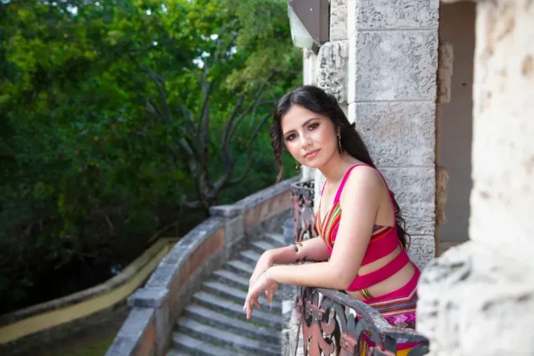 This is an image of a lady wearing a custom made ethnic dress made by Betzabe Pujaico Designs in North Miami, FL.