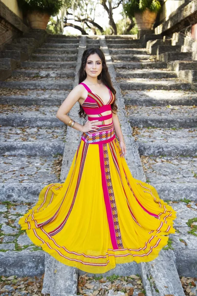 This is an image of a lady wearing a custom made ethnic dress made by Betzabe Pujaico Designs in North Miami, FL.