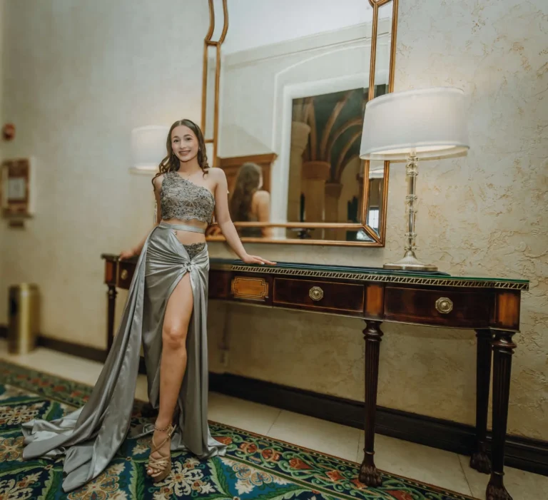 This is an image of a lady wearing a custom made formal dress made by Betzabe Pujaico Designs in North Miami, FL.