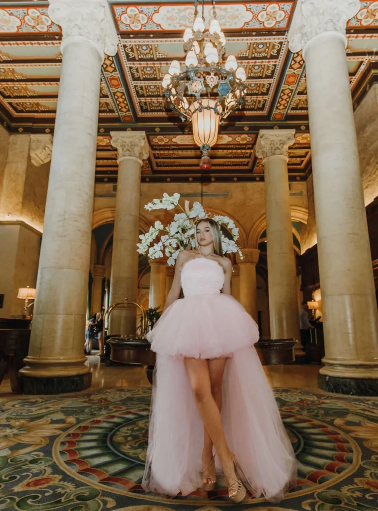 This is an image of a lady wearing a custom made formal dress made by Betzabe Pujaico Designs in North Miami, FL.