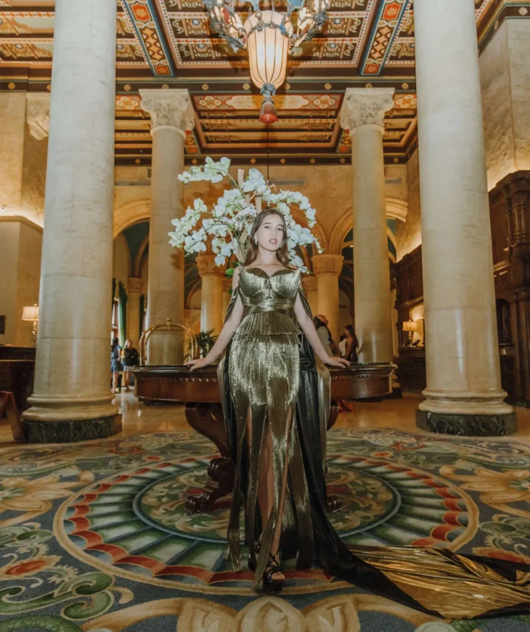 This is an image of a lady wearing a custom made formal dress made by Betzabe Pujaico Designs in North Miami, FL.