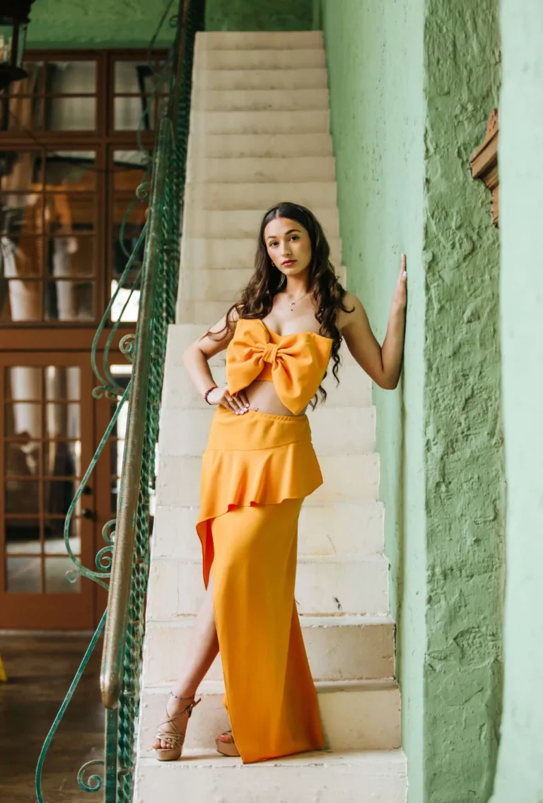 This is an image of a lady wearing a custom made formal dress made by Betzabe Pujaico Designs in North Miami, FL.