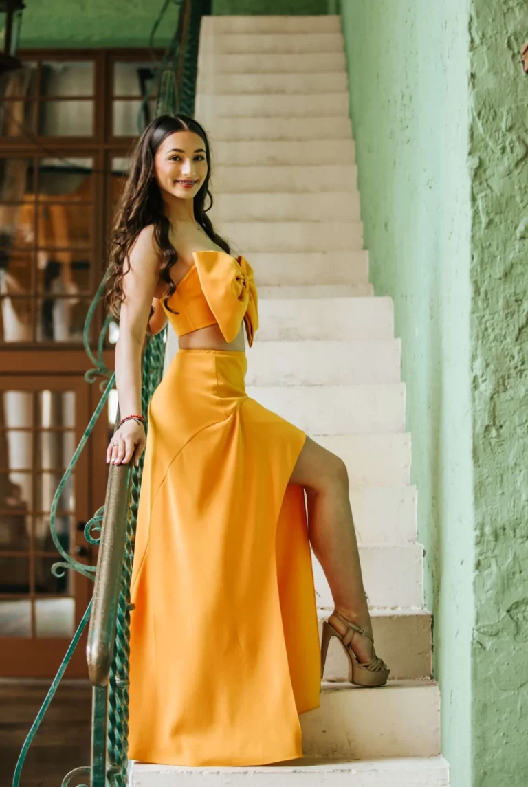 This is an image of a lady wearing a custom made formal dress made by Betzabe Pujaico Designs in North Miami, FL.