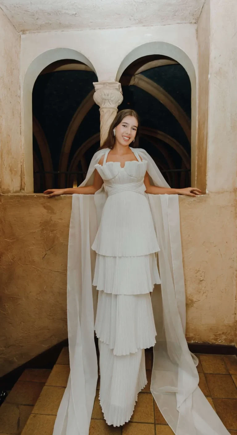 This is an image of a lady wearing a custom made formal dress made by Betzabe Pujaico Designs in North Miami, FL.