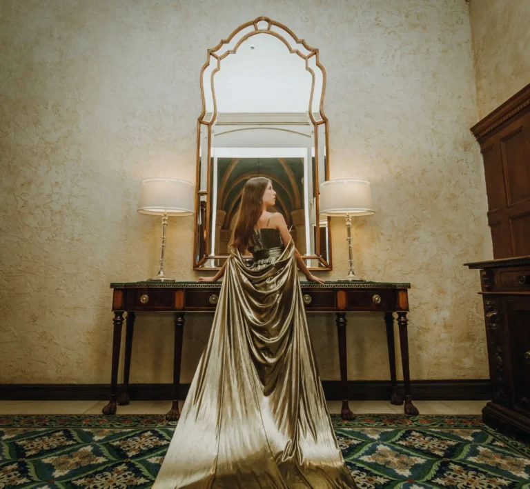 This is an image of a lady wearing a custom made formal dress made by Betzabe Pujaico Designs in North Miami, FL.