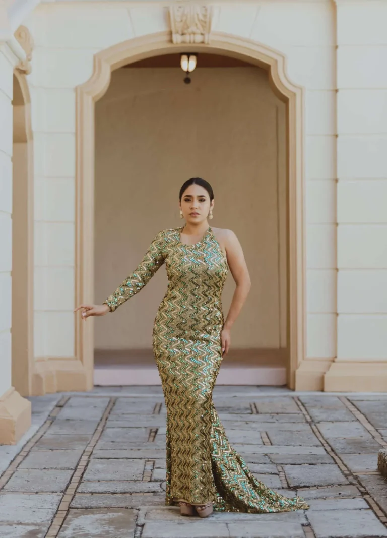 This is an image of a lady wearing a custom made formal dress made by Betzabe Pujaico Designs in North Miami, FL.