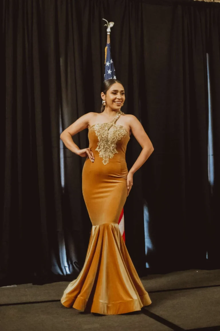 This is an image of a lady wearing a custom made formal dress made by Betzabe Pujaico Designs in North Miami, FL.