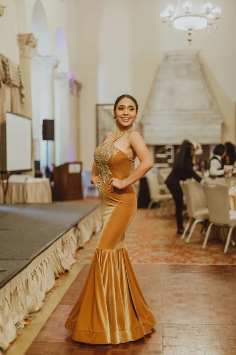 This is an image of a lady wearing a custom made formal dress made by Betzabe Pujaico Designs in North Miami, FL.