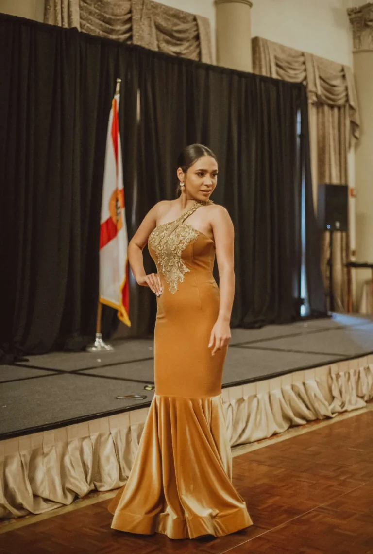 This is an image of a lady wearing a custom made formal dress made by Betzabe Pujaico Designs in North Miami, FL.