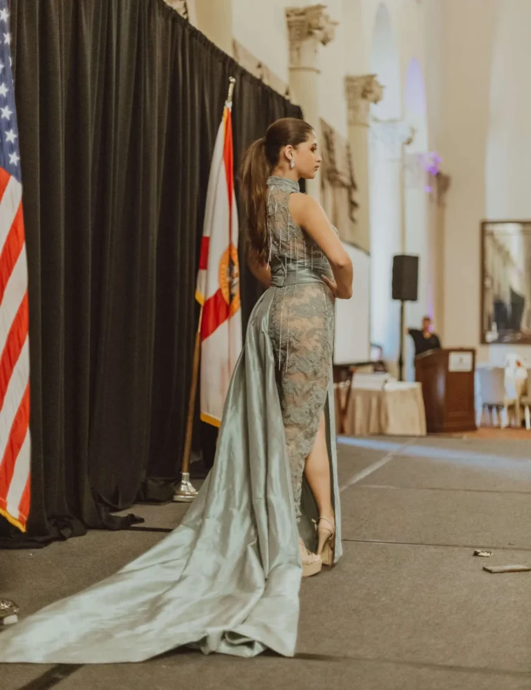 This is an image of a lady wearing a custom made formal dress made by Betzabe Pujaico Designs in North Miami, FL.