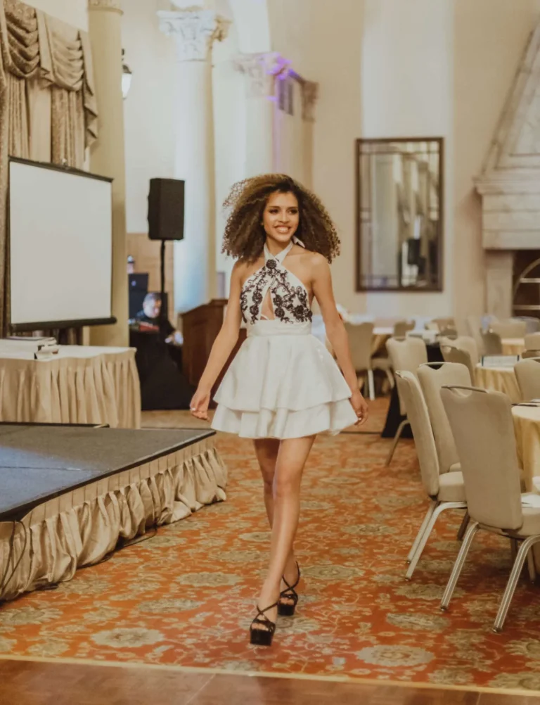 This is an image of a lady wearing a custom made formal dress made by Betzabe Pujaico Designs in North Miami, FL.