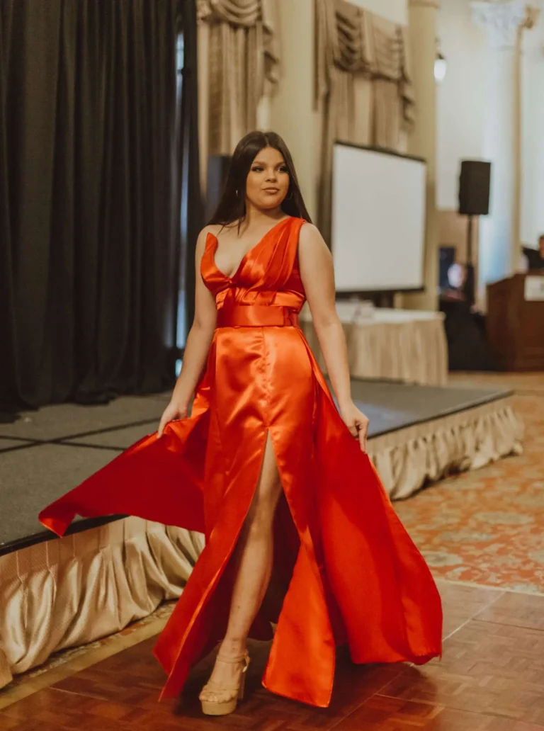 This is an image of a lady wearing a custom made formal dress made by Betzabe Pujaico Designs in North Miami, FL.