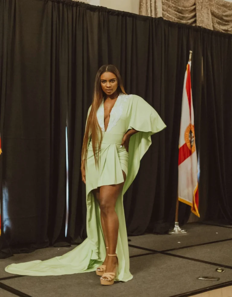 This is an image of a lady wearing a custom made formal dress made by Betzabe Pujaico Designs in North Miami, FL.