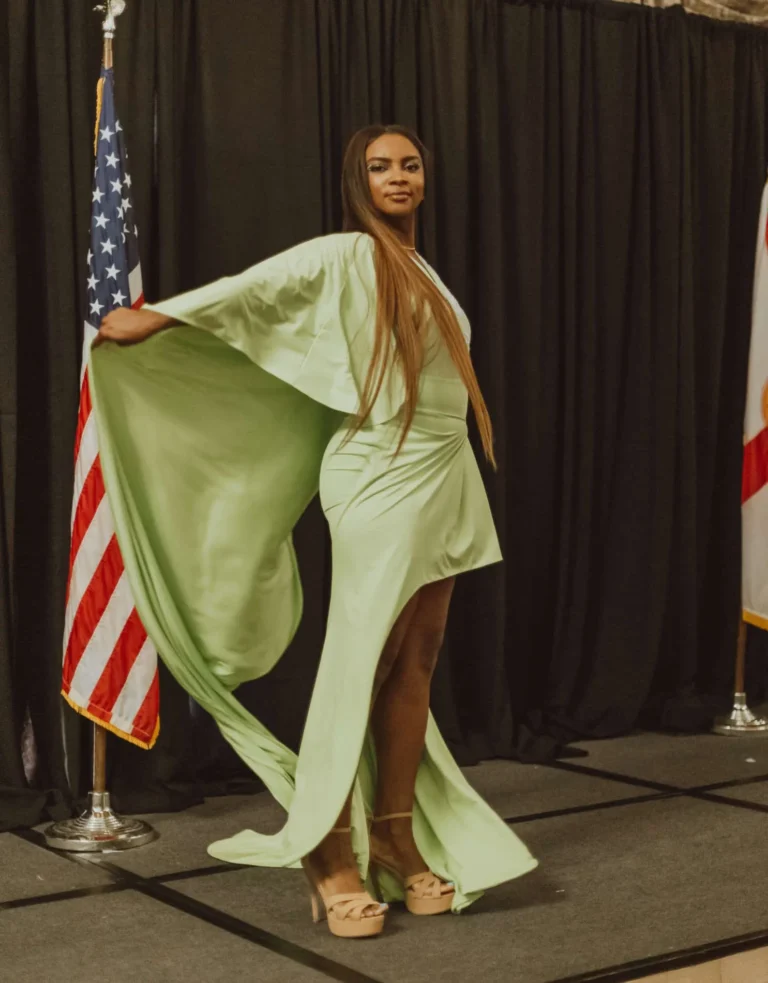 This is an image of a lady wearing a custom made formal dress made by Betzabe Pujaico Designs in North Miami, FL.