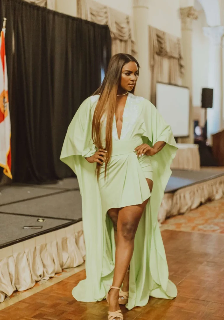 This is an image of a lady wearing a custom made formal dress made by Betzabe Pujaico Designs in North Miami, FL.