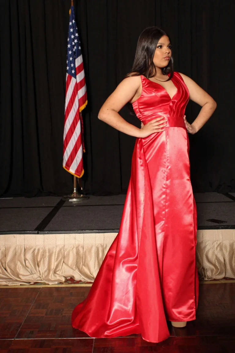This is an image of a lady wearing a custom made formal dress made by Betzabe Pujaico Designs in North Miami, FL.