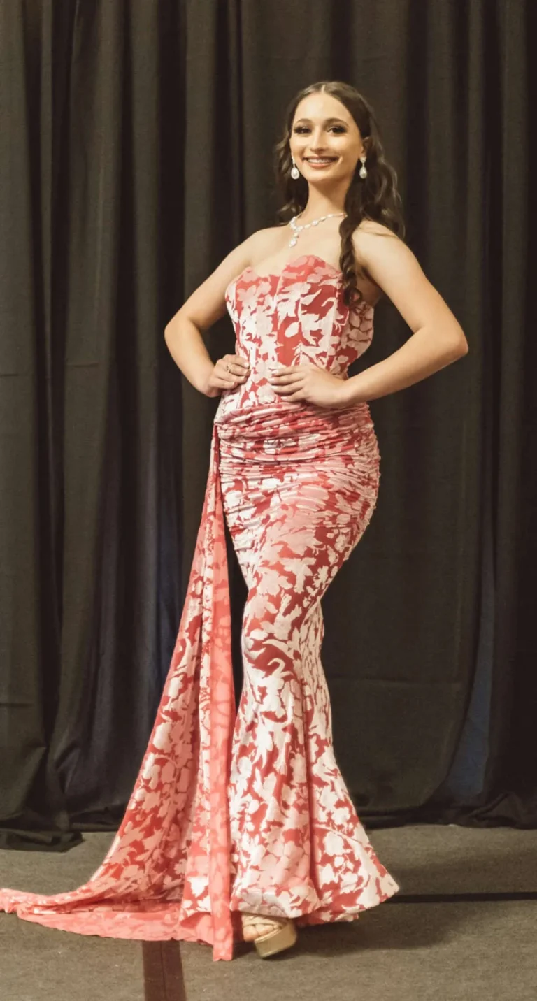 This is an image of a lady wearing a custom made formal dress made by Betzabe Pujaico Designs in North Miami, FL.