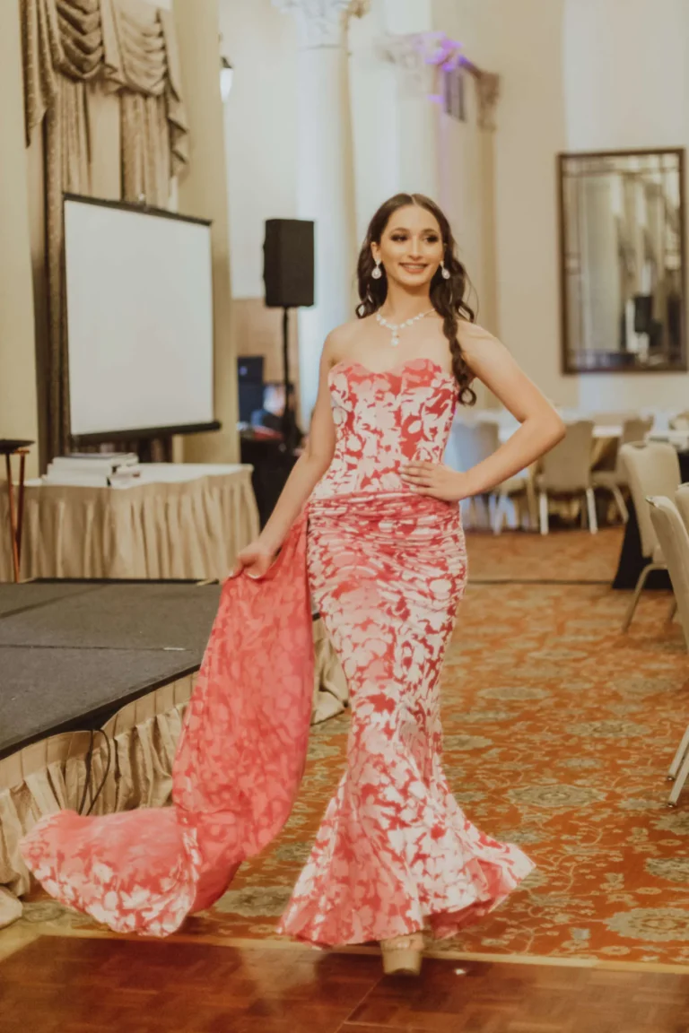 This is an image of a lady wearing a custom made formal dress made by Betzabe Pujaico Designs in North Miami, FL.