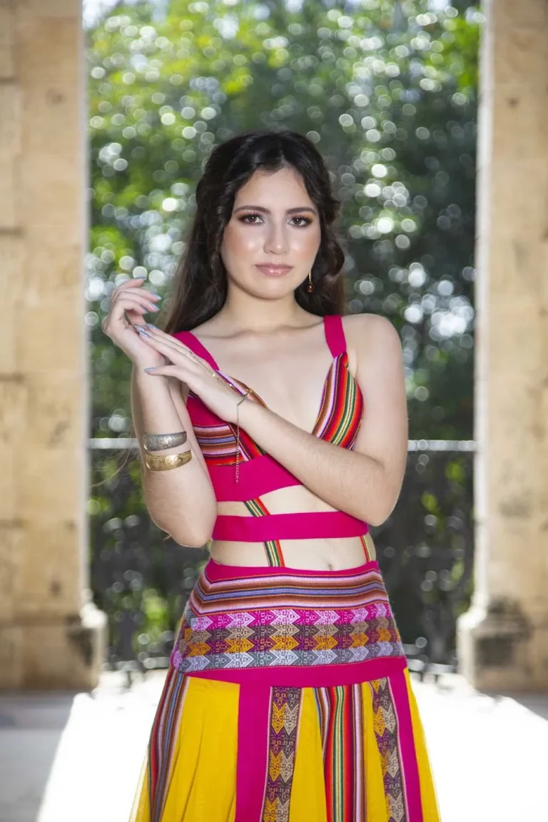 This is an image of a lady wearing a custom made inca style dress made by Betzabe Pujaico Designs in North Miami, FL.