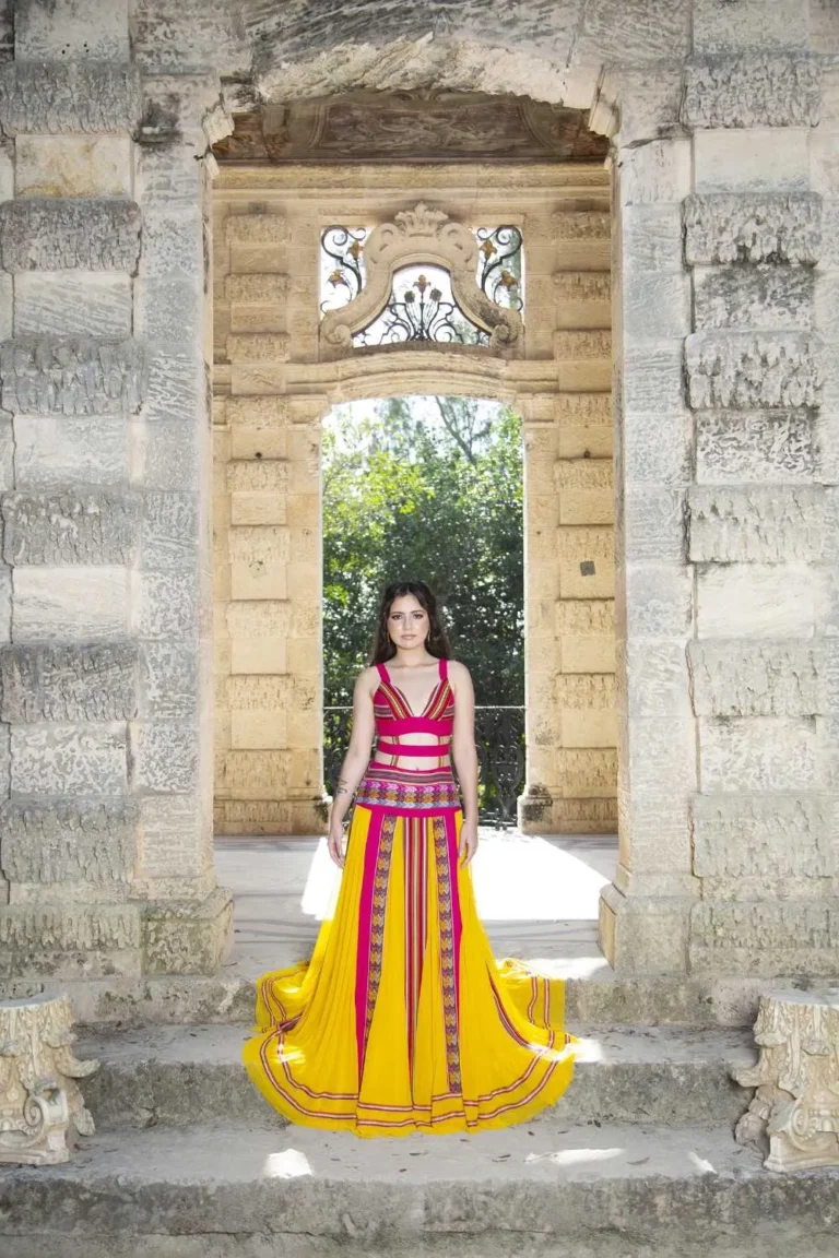 This is an image of a lady wearing a custom made inca style dress made by Betzabe Pujaico Designs in North Miami, FL.