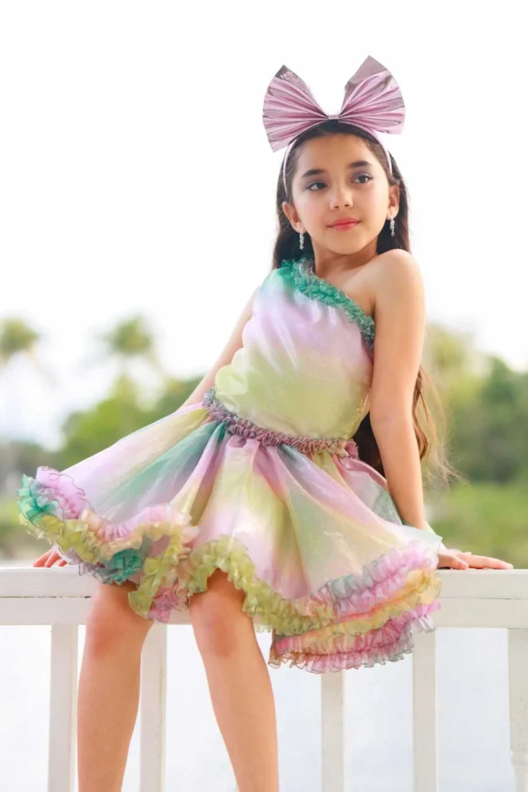 This is an image of a lady wearing a custom made outfits for children made by Betzabe Pujaico Designs in North Miami, FL.