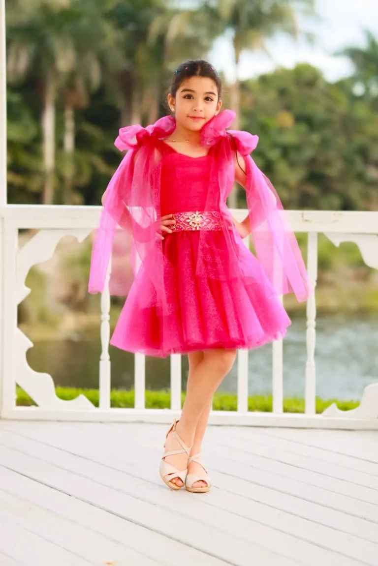 This is an image of a lady wearing a custom made outfits for children made by Betzabe Pujaico Designs in North Miami, FL.