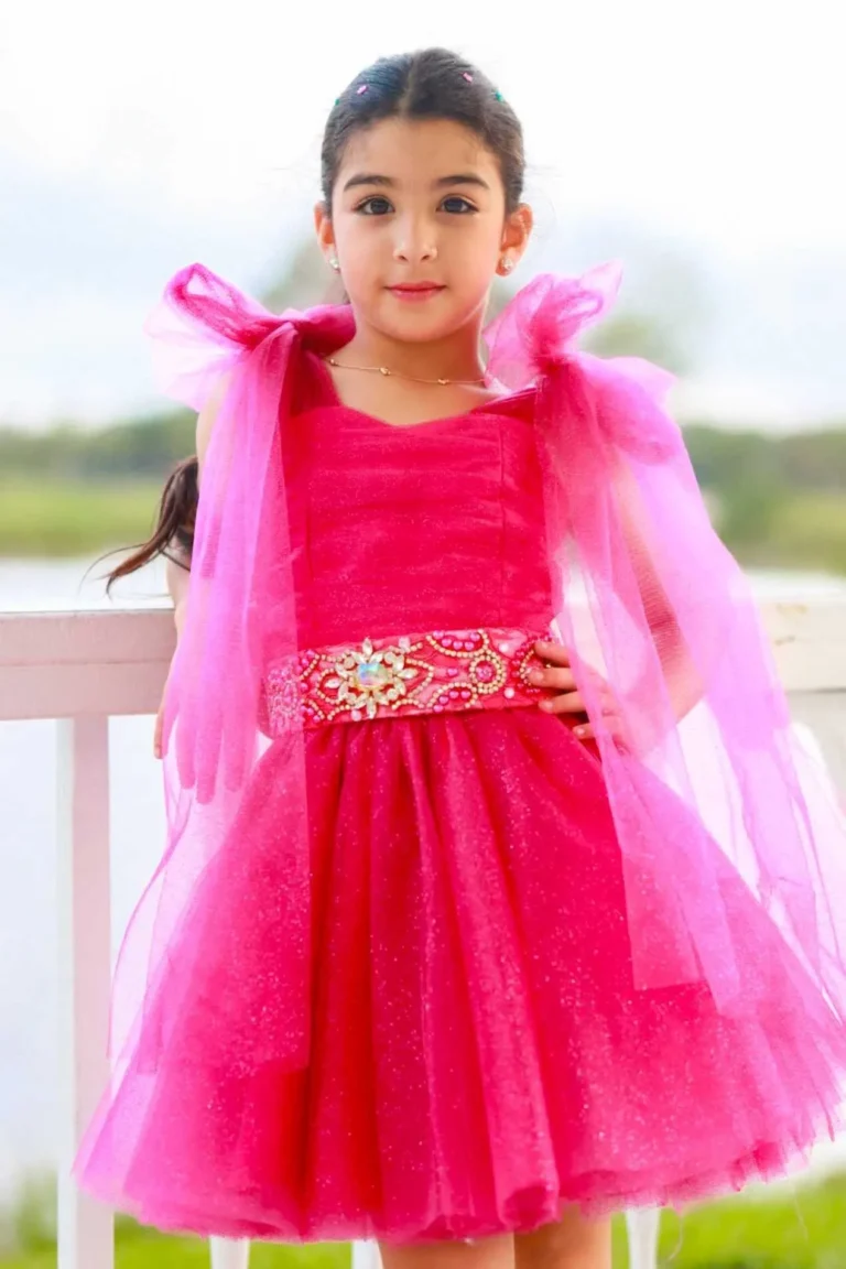 This is an image of a lady wearing a custom made outfits for children made by Betzabe Pujaico Designs in North Miami, FL.