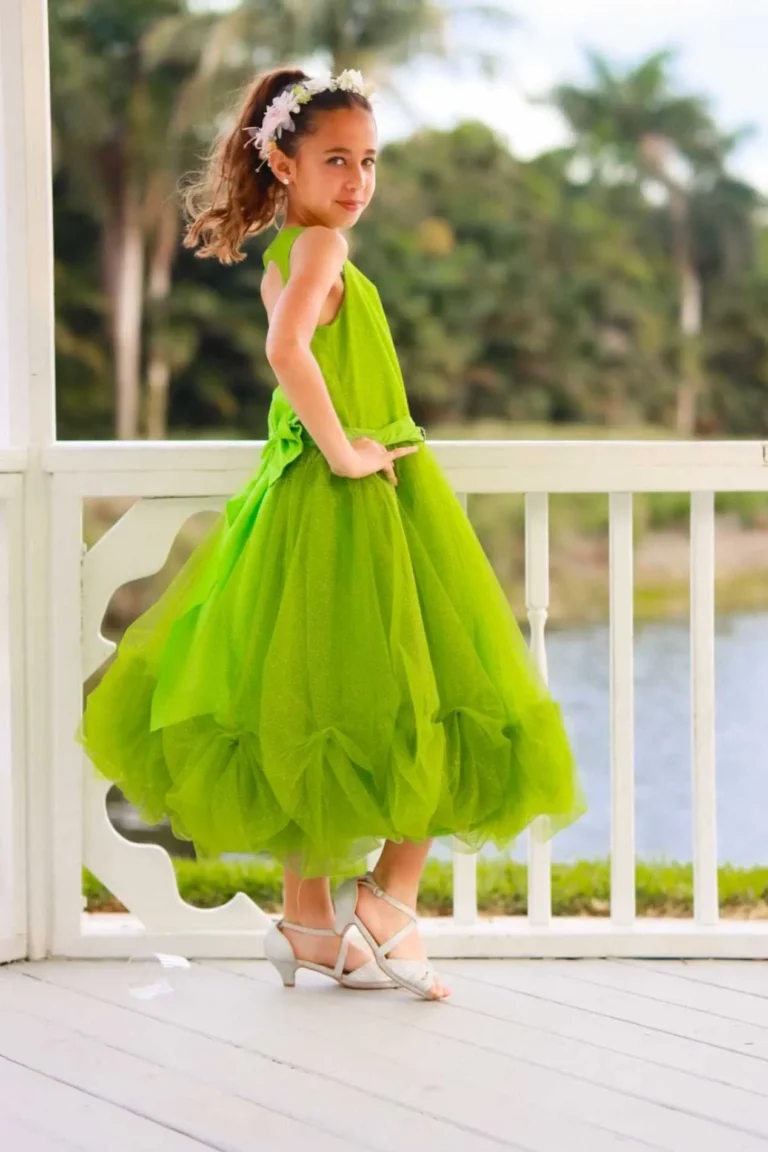 This is an image of a lady wearing a custom made outfits for children made by Betzabe Pujaico Designs in North Miami, FL.