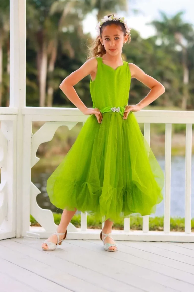 This is an image of a lady wearing a custom made outfits for children made by Betzabe Pujaico Designs in North Miami, FL.