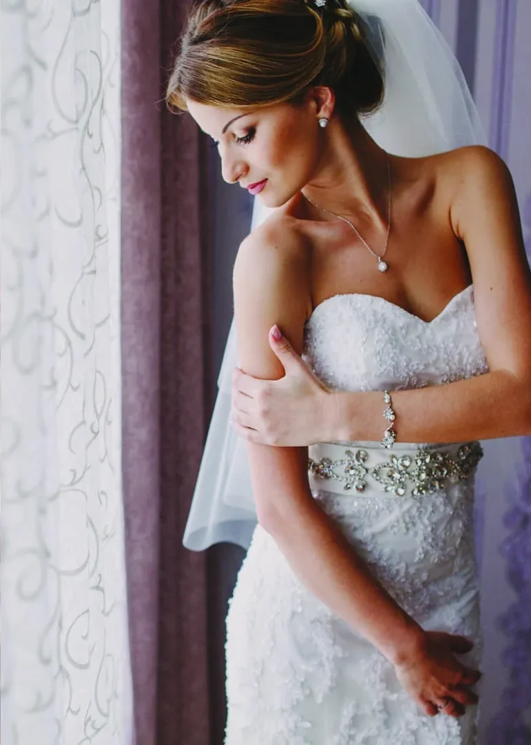 This is an image of a lady wearing a custom made wedding dress made by Betzabe Pujaico Designs in North Miami, FL.